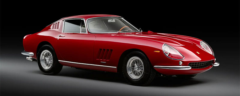 Red Ferrari 275 GTB on dark background